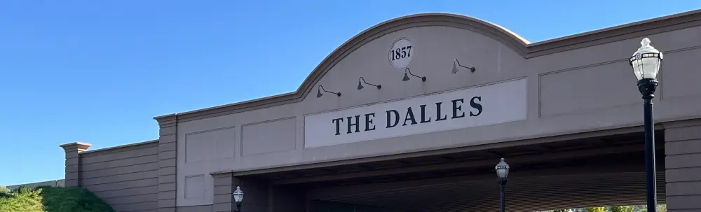 Entrance sign reading &ldquo;The Dalles&rdquo; with 1857 above it.