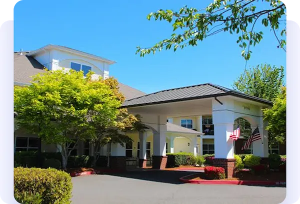 Entrance of a landscaped building with an American flag.