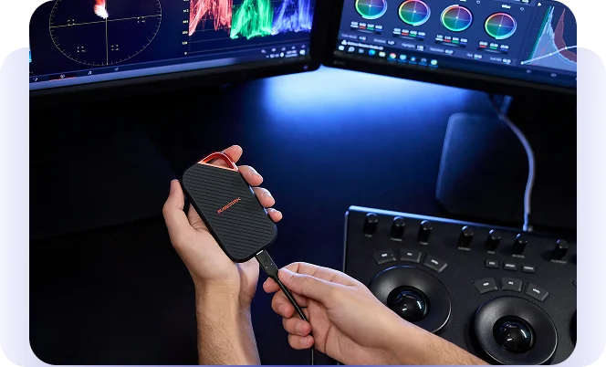 image12 (1) Hands connecting a portable drive to a video-editing workstation.
